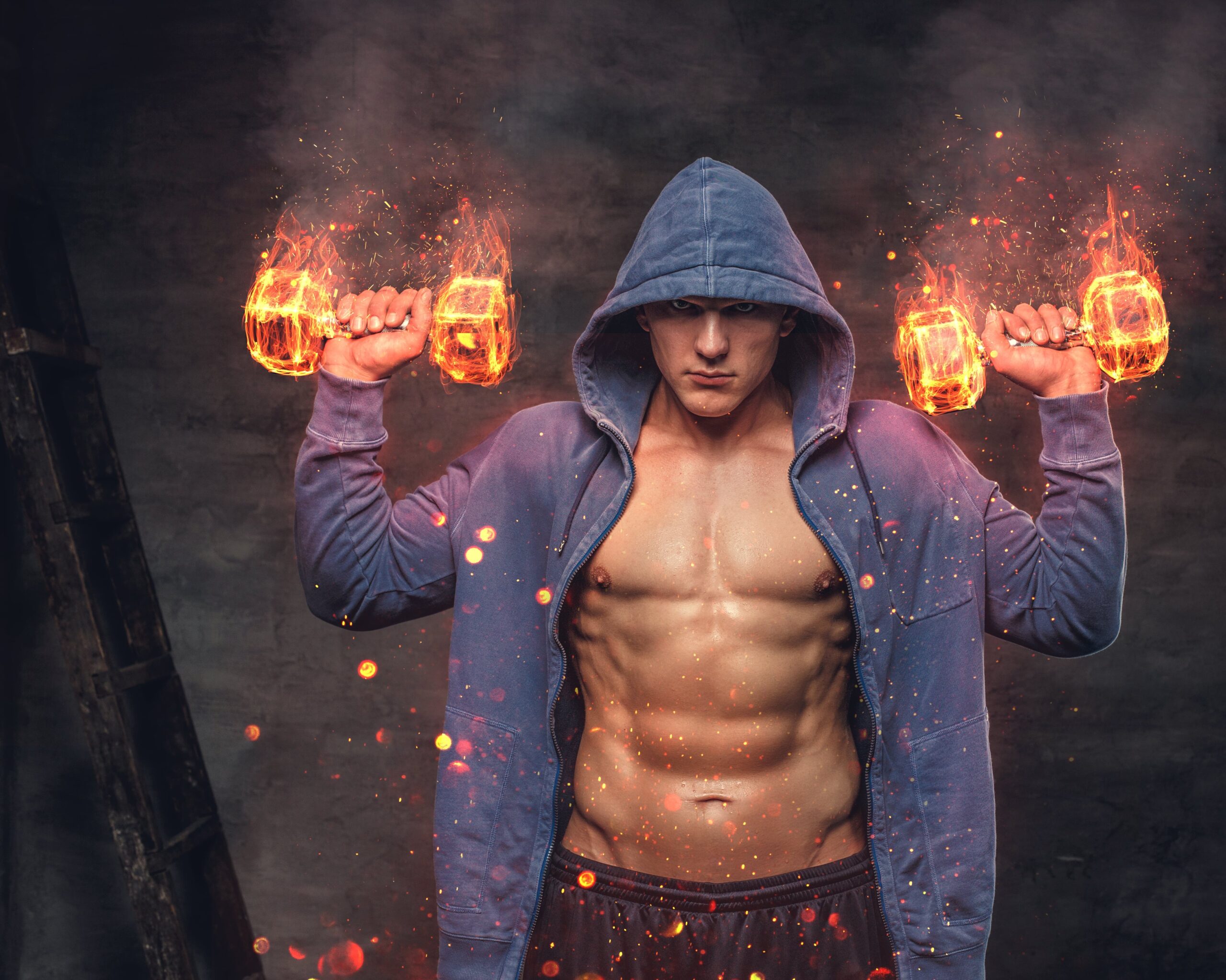 abdominal-male-blue-hoodie-holds-burning-dumbbells-with-smoke-grey-background-min